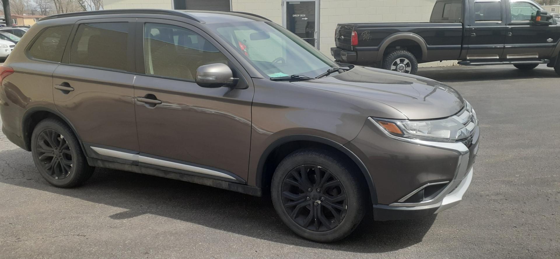 2016 Mitsubishi Outlander SE AWD (JA4AZ3A37GZ) with an 2.4L L4 DOHC 16V engine, CVT transmission, located at 2015 Cambell Street, Rapid City, SD, 57701, (605) 342-8326, 44.066433, -103.191772 - CARFAX AVAILABLE - Photo#4